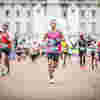 A man running the London marathon for Fight for Sight, looking pleased as he approaches the finish line