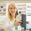 Dr Jasmina Kapetanovic in a laboratory smiling in front of a microscope