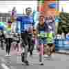 Laine and Pat Fischer a white couple in their photos run triumphantly over the finish line of the Berlin Marathon.