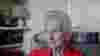 Elizabeth Maxwell in profile - she sits in a chair wearing a red blouse with a blue scarf
