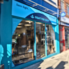 West Norwood Fight for Sight Charity Shop, a turquoise exterior with our navy logo and the words Save Sight. Change Lives.