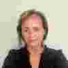 A headshot of Oonagh. She is wearing a black shirt and her hair is pulled back.