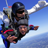 Photo of a man and a woman tandem skydiving